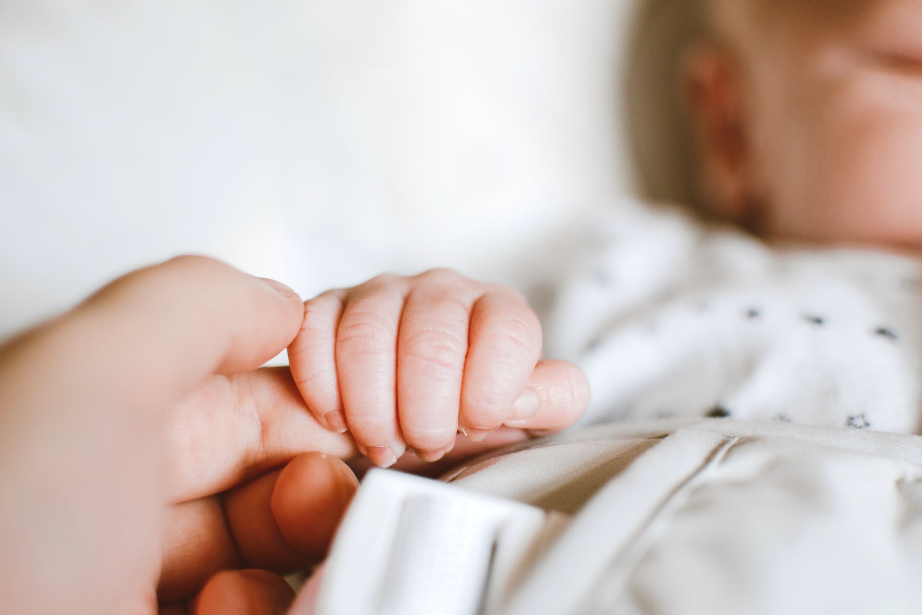 person holding baby s hand