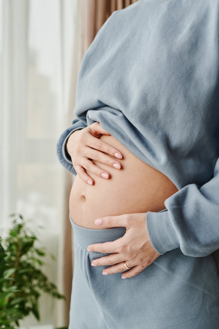 pregnant woman touching her belly